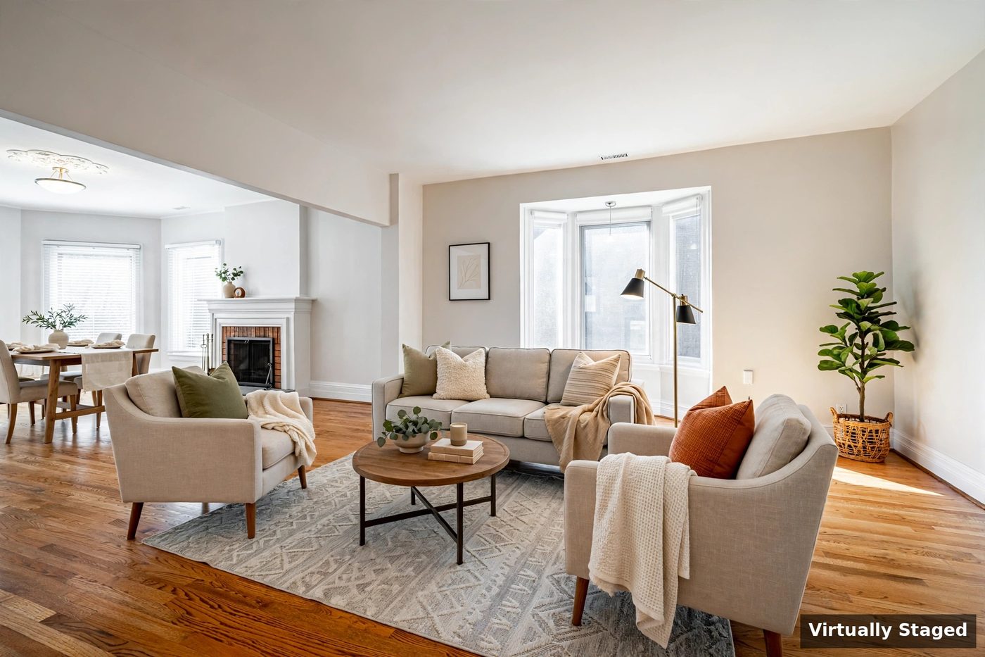 The same living and dining room virtually staged with a sofa, armchairs, a rug, and a dining set; the words Virtually Staged appear as a label in the corner of the image